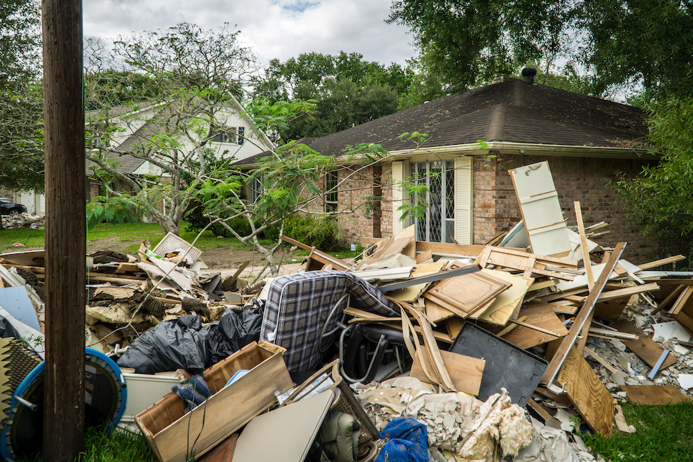 storm damaged house with debris